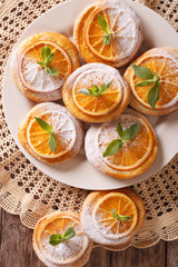Festive cookies with oranges closeup on a plate. vertical top view
