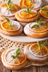 Festive cookies with oranges closeup on a plate. Vertical
