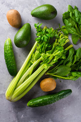 ingredients for green smoothie with avocado, parsley,spinach,cuc