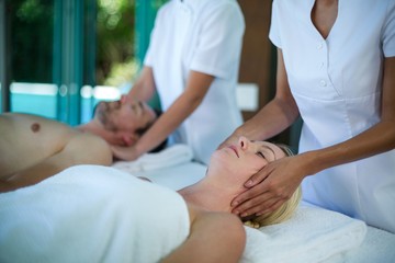 Fototapeta na wymiar Woman receiving a face massage from masseur in spa