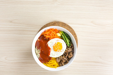 pouring sause to bibimbap , korean dish