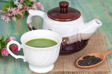 green tea with milk or hot matcha latte on wood