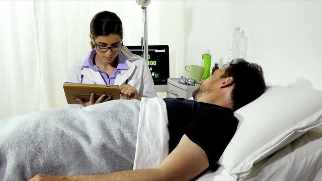 Female doctor in hospital showing analysis to patient on tablet