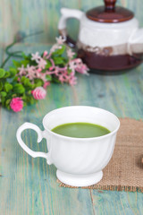 Obraz na płótnie Canvas green tea with milk or hot matcha latte on wood