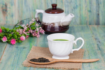 green tea with milk or hot matcha latte on wood