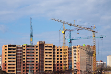 Fototapeta na wymiar Construction site with cranes on sky background