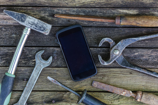 Repair Phone Using Tools. Old Workshop With New Technologies. 