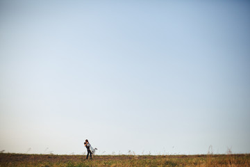 Love and infinity - newlyweds kiss in the front of blue sky