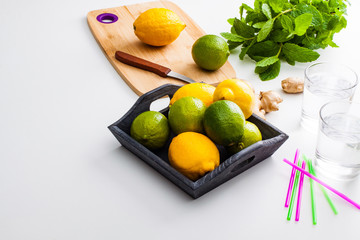 Ingredients for homemade lemonade, view from above. Lemon, lime and mint for refresh water.
