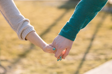 Close up hand in hand of couple in love
