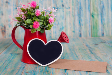 heart shape and watering on wood table