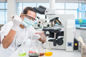 Fototapeta premium Serious clinician studying chemical element on tester and lectur