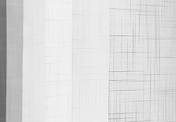 vertical white fabric blinds in the office, background abstraction