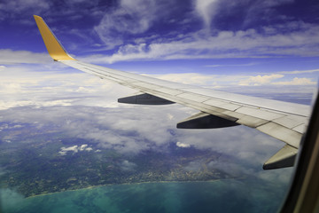 View from airplane window. Wing of an airplane flying above the