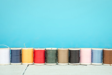 Bobbins with colorful threads background, Sewing background