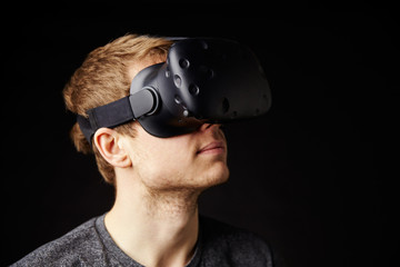 Young Man Wearing Virtual Reality Headset In Studio