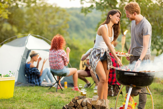 Male and female lovingly look each other while baked barbecue