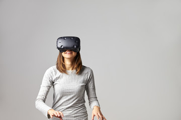 Young Woman Wearing Virtual Reality Headset In Studio