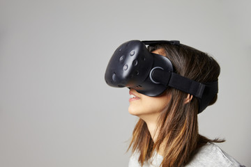 Young Woman Wearing Virtual Reality Headset In Studio