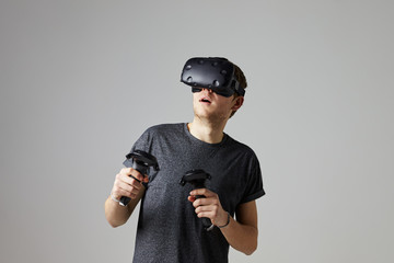Man In Studio Wearing Virtual Reality Headset Playing Game