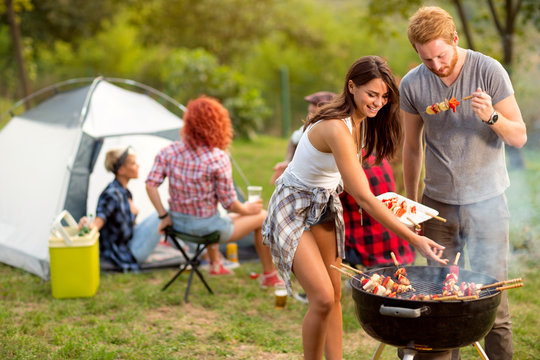 Young brunette with boyfriend serving on plate barbecue