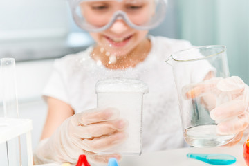 little girl with flasks for chemistry