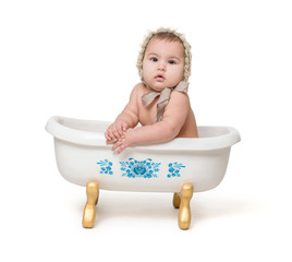 little baby  sitiing in a bath