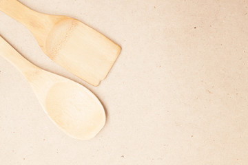 various wood made kitchen tools on a natural wood background