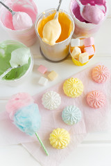 Top view of the process of preparation of a colored meringues and marshmallows