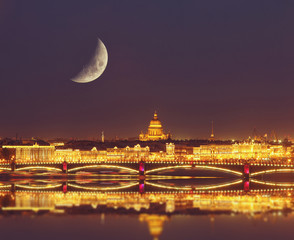 Fototapeta premium Night view of the Neva river and St. Isaac's Cathedral and the Troitskiy Bridge. Travel background