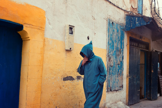 Man walking along an alley in the medina of Essaouira, Morocco