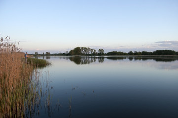 Angler on the lake in the evening