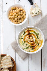 Hummus in bowl on white wooden table