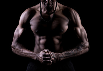 Obraz na płótnie Canvas Studio shot of muscular afro-american man posing with black background