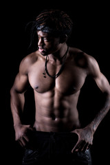 Fototapeta na wymiar Studio shot of muscular afro-american man posing with black background