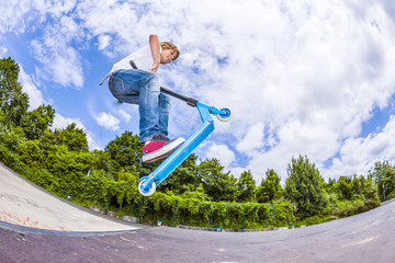 boy with scooter is going airborne