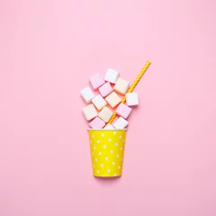 Gordijnen Top view of the pastel marshmallows on a pink background. Minimal style. © anastasiafotoss