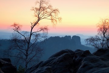Deep misty valley within sunset. Foggy and misty moment on sandstone view poin