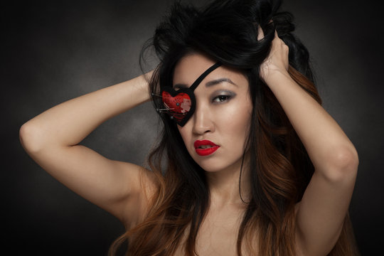 Woman with heart shape eye patch