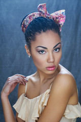 Portrait of a beautiful young African girl with elegant head bow