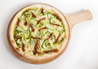 Green pizza on wooden tray