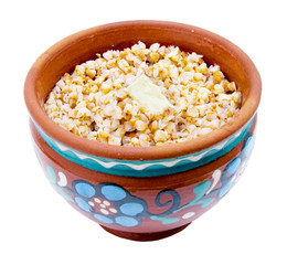 Buckwheat kasha with a piece of a butter in a clay pot