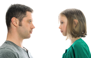Father and daughter in front of each other. Isolated on white.