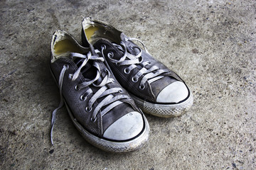 Old sneakers on grunge background