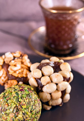 Turkish sweets from carrot juice with walnuts, hazelnuts and pistachio petals. Oriental dessert made without any sugar