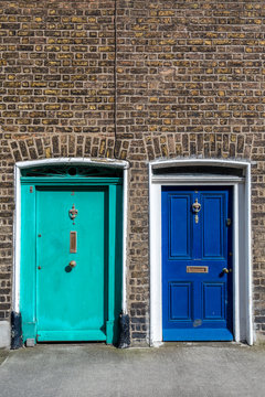 Two painted exterior wooden doors next to each other in traditional style, Dublin Ireland.