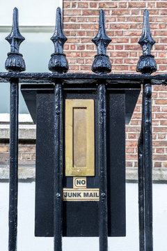 No junk mail sign on mailbox on fence outdoors by a building, Dublin Ireland. 