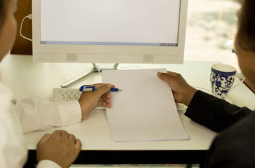 Business people hand holding pen with paperwork