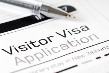 visitor visa application form with pen