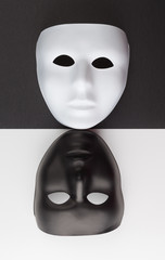 Black and white masks upside down on contrasting backgrounds, Personality change concept